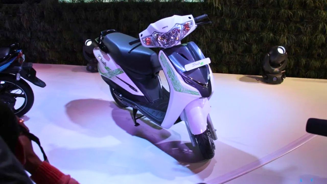Here is image of Hero Duet Electric Scooter in black and white colour which is placed in an event of hero