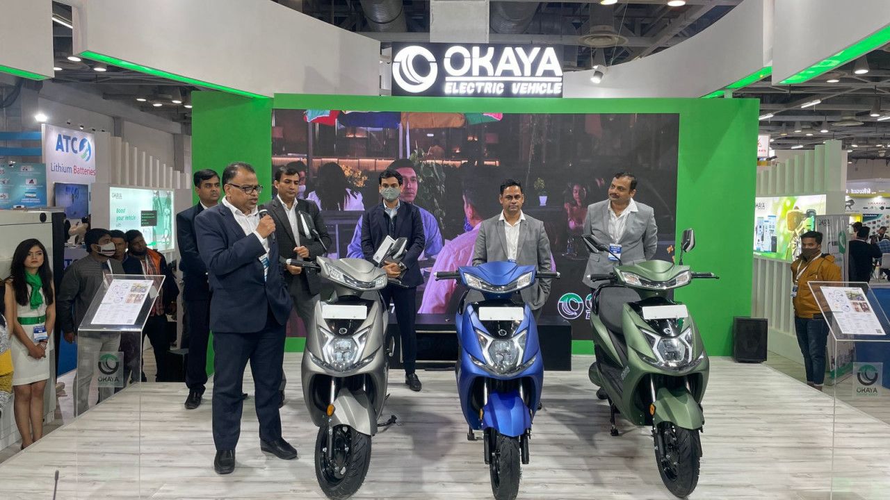Here is image of a group of people Showing electric scooters of Okaya EV